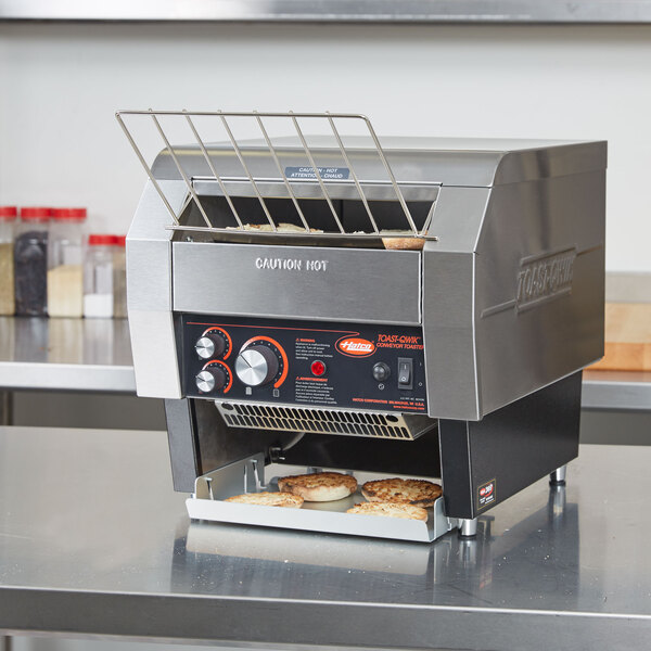 A Hatco Toast Qwik conveyor toaster with bread inside.