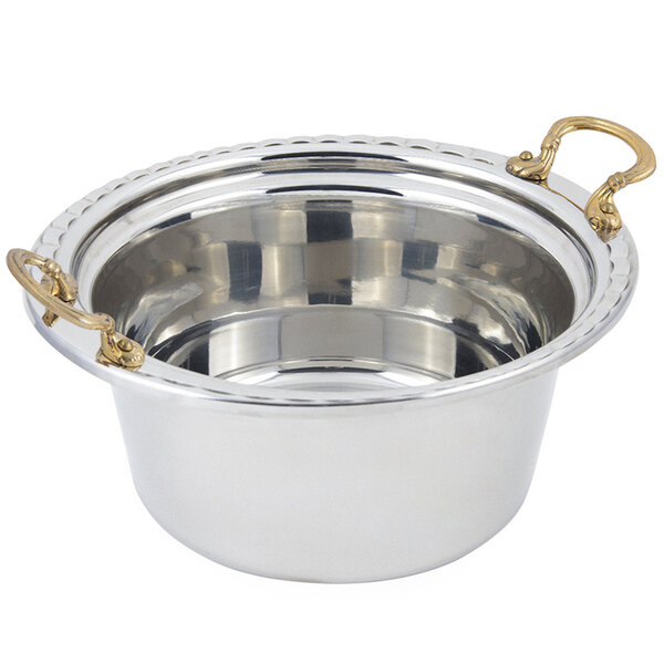 A stainless steel casserole food pan with round brass handles.