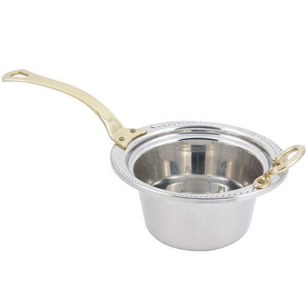 A stainless steel food pan with a laurel design and long brass handle.