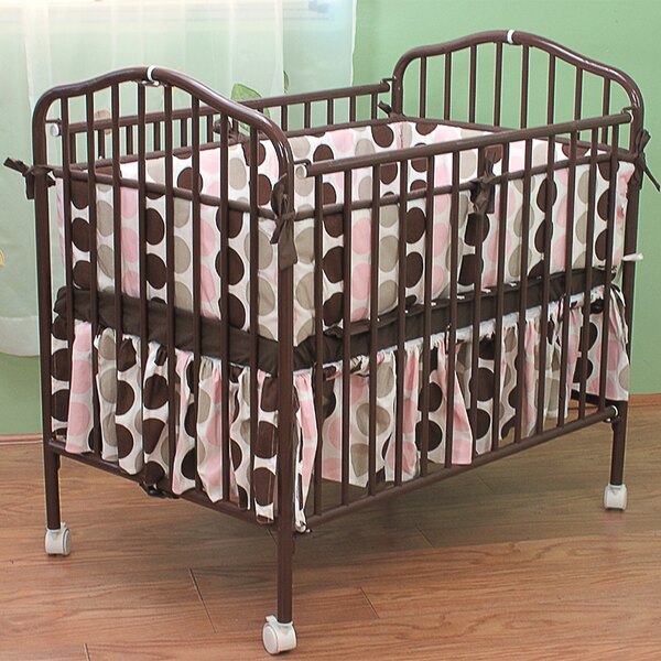 A chocolate colored metal L.A. Baby folding crib.