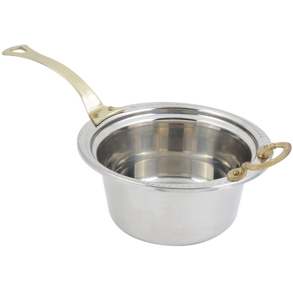 A silver stainless steel Bon Chef casserole pan with a brass handle decorated with a laurel design.