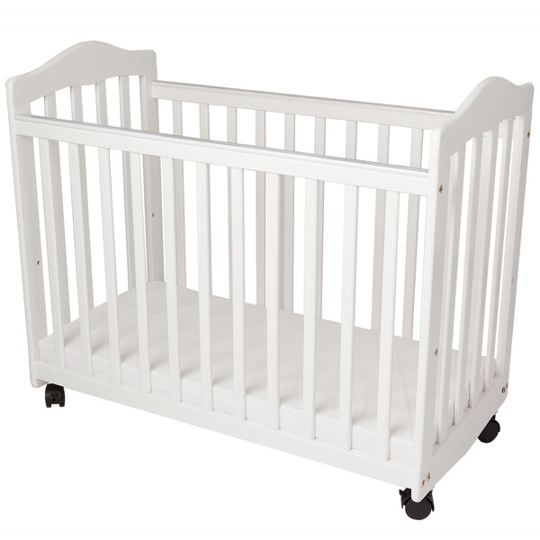 A white L.A. Baby Bedside Manor cradle with wheels.