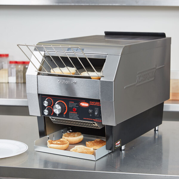 A Hatco conveyor toaster with bread inside.