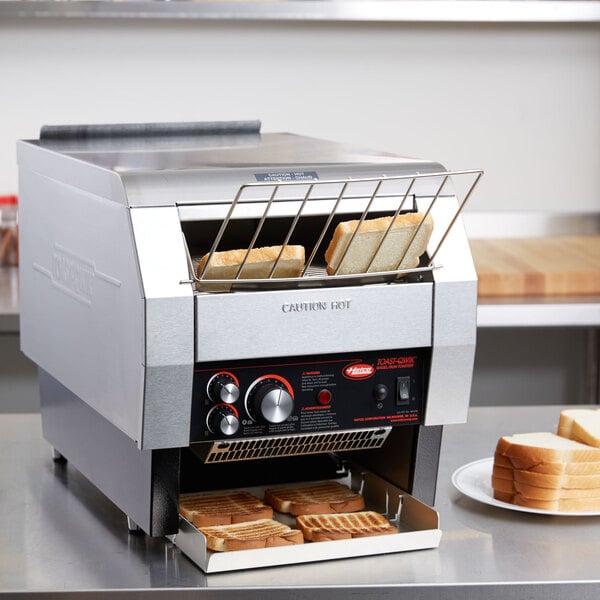 A Hatco Toast Qwik conveyor toaster with a rack of toast.