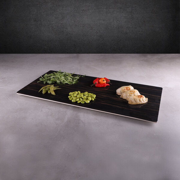 A rectangular faux zebra wood melamine serving board with vegetables and meat on it.