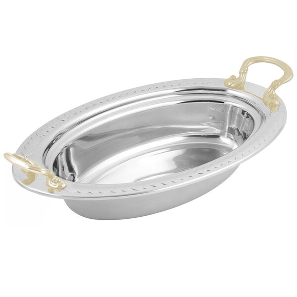 A silver oval Bon Chef food pan with round brass handles and a laurel design.