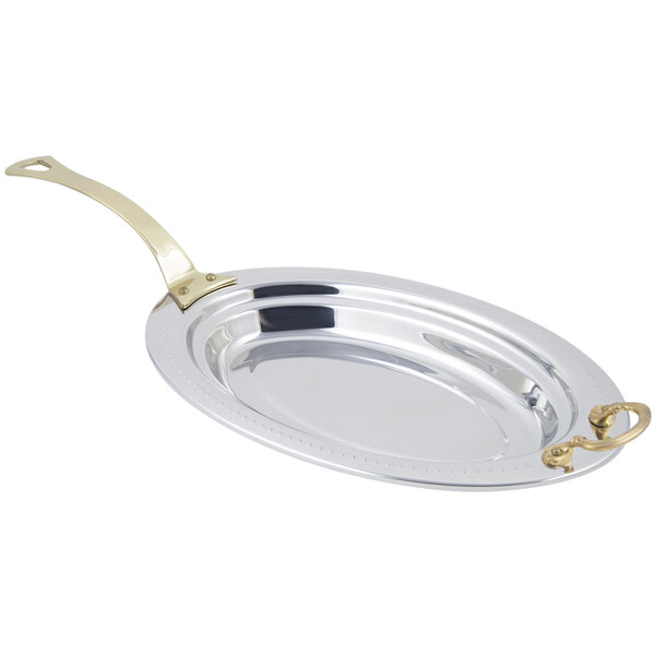 A silver stainless steel Bon Chef oval food pan with a long brass handle.