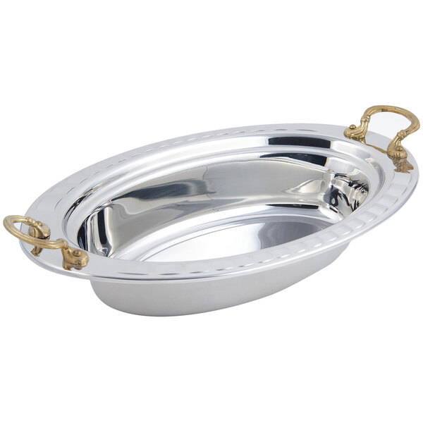 A silver stainless steel oval food pan with round brass handles.