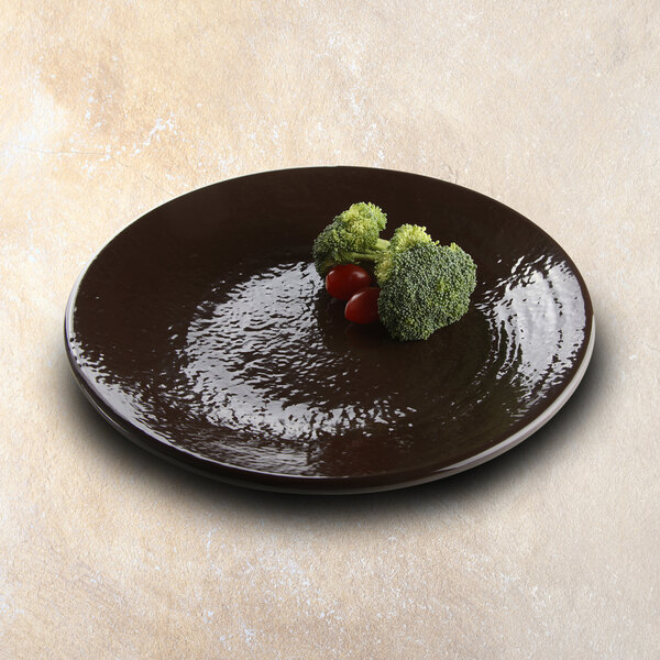 An Elite Global Solutions Aubergine-colored melamine plate with broccoli and tomatoes on it.