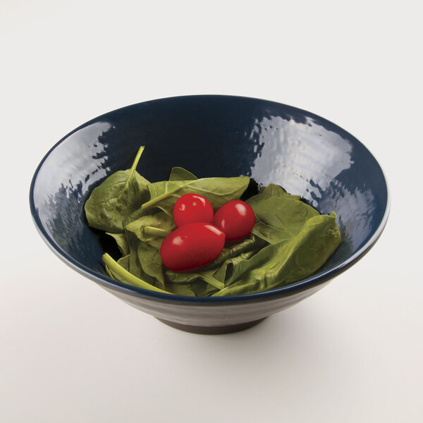 A lapis-colored Elite Global Solutions melamine bowl filled with spinach and tomatoes.