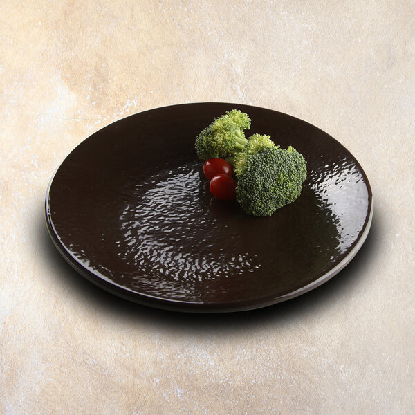 An Elite Global Solutions Aubergine-colored melamine plate with broccoli and cherry tomatoes on it.