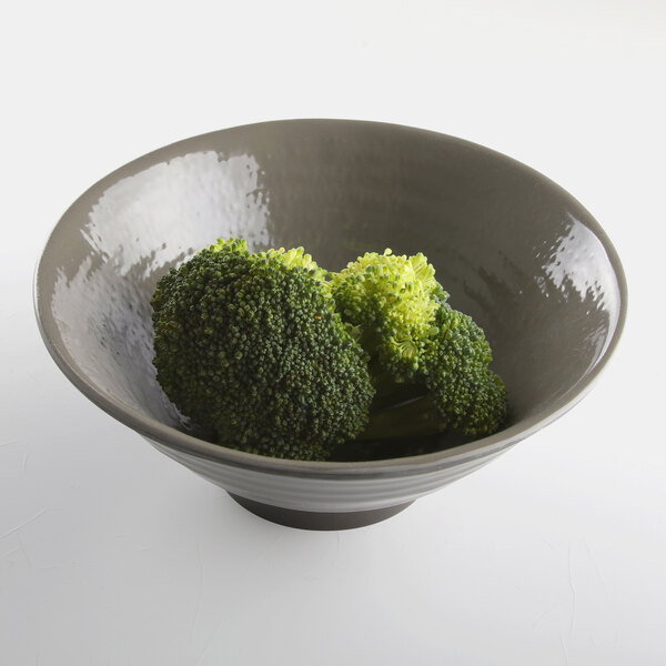 A Elite Global Solutions Pebble Creek mushroom-colored melamine bowl filled with broccoli and other vegetables.