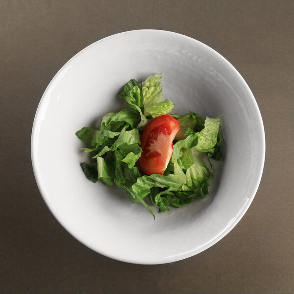 An Elite Global Solutions Pebble Creek Abyss-colored melamine bowl filled with lettuce and tomatoes.