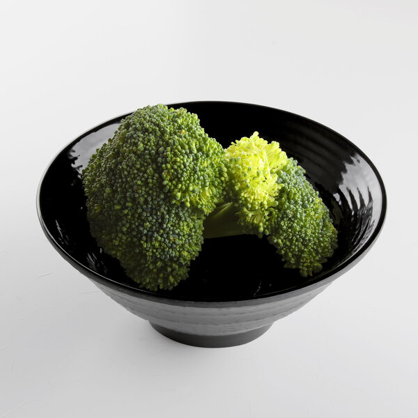 A black Elite Global Solutions melamine bowl filled with broccoli on a white surface.