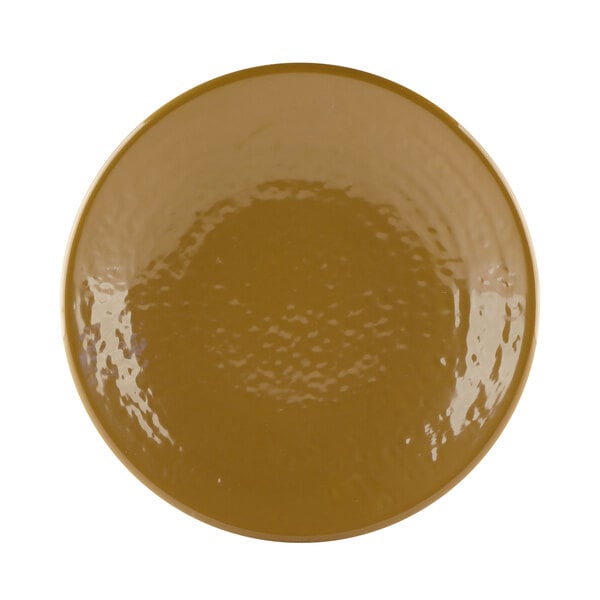 A close-up of an Elite Global Solutions Pebble Creek Tapenade-colored plate with a brown surface.