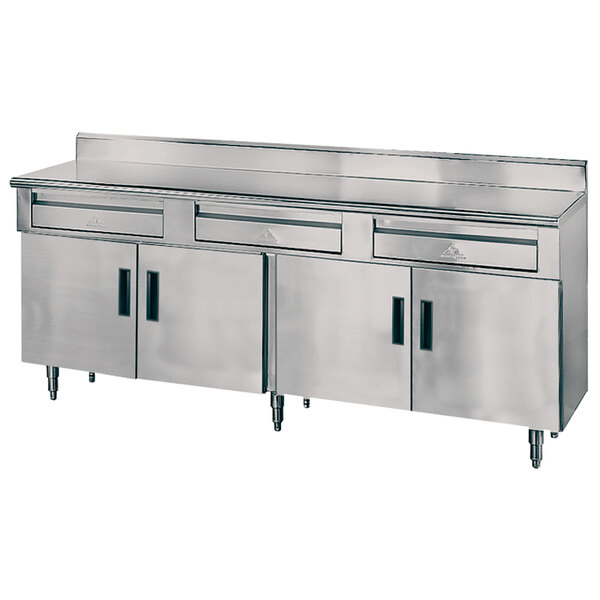 A stainless steel Advance Tabco work table with 3 drawers.
