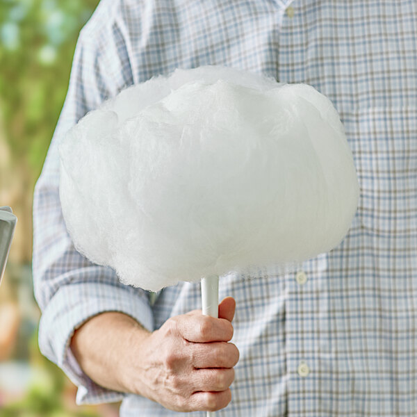 A man holding a large cotton candy made with Great Western Mint Green Floss Sugar.
