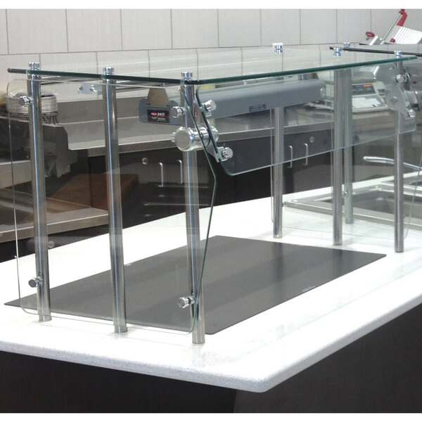 A stainless steel and glass self service food shield by Advance Tabco on a counter.