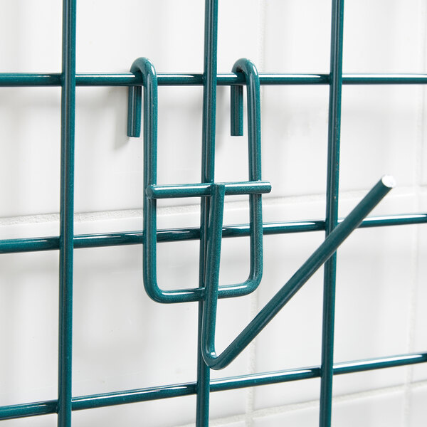 A green metal wire cylinder holder with a hook on it.