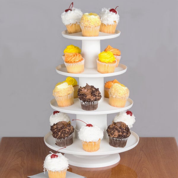 A white Wilton 4-tier dessert display stand with cupcakes on each tier.
