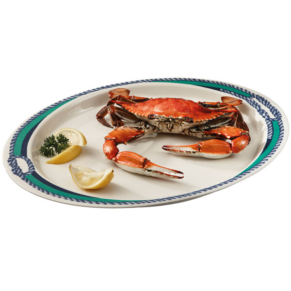A crab on a GET Freeport oval platter with lemon slices and a wedge.