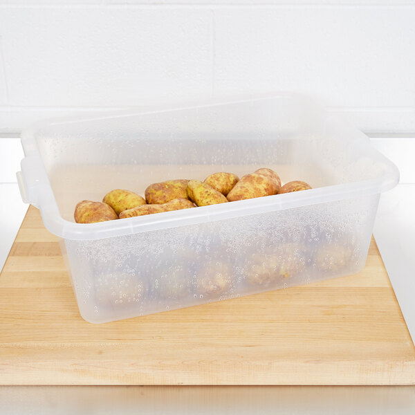 A Vollrath Color-Mate clear plastic container holding potatoes.