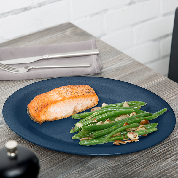 A GET Texas Blue oval platter with salmon and green beans on it.