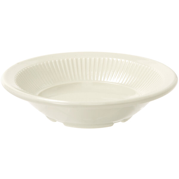 A close up of a white bowl with a ribbed edge.