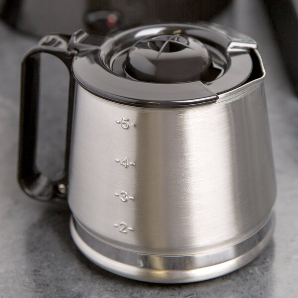 A stainless steel Hamilton Beach coffee carafe with a lid.