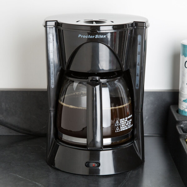 A black Proctor Silex coffee maker on a counter.