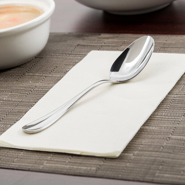An Oneida Bague stainless steel oval bowl soup/dessert spoon on a napkin.