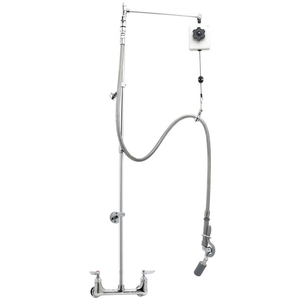A T&S wall mounted pre-rinse faucet with a hose and metal spray valve.