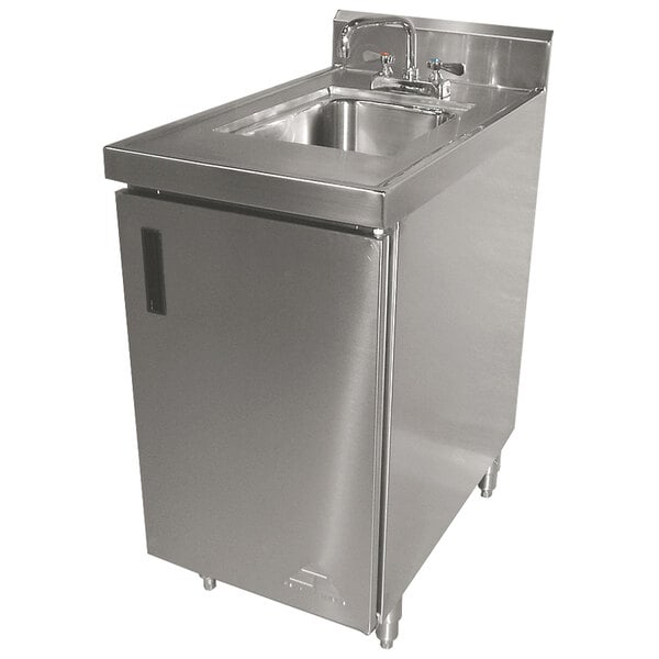 A stainless steel Advance Tabco sink cabinet with a faucet and side drain.