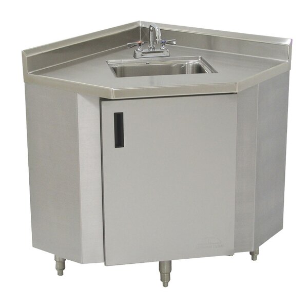 A stainless steel Advance Tabco corner sink cabinet with a door.