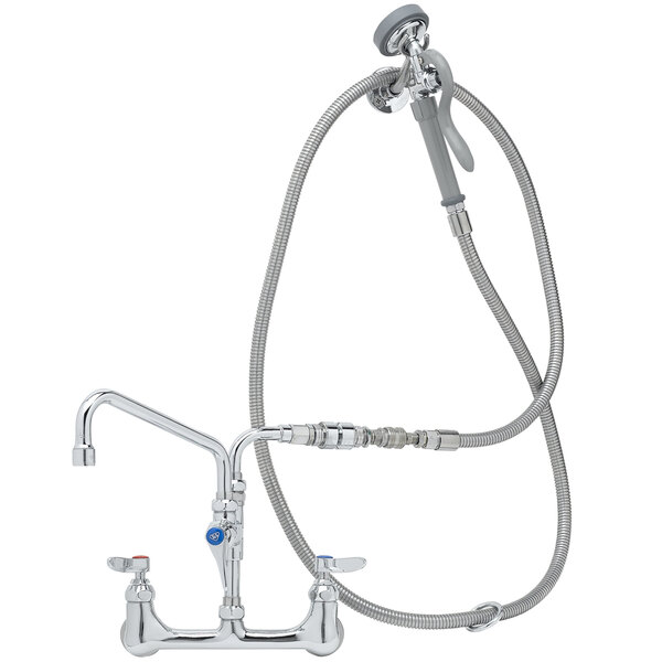 A T&S chrome wall mounted pre-rinse faucet with hose and hand sprayer.