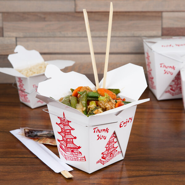 A Fold-Pak Pagoda take-out box filled with food and chopsticks.
