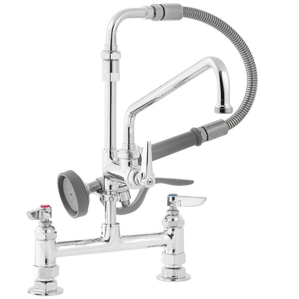 A T&S chrome deck mounted pre-rinse faucet with two handles and a sprayer.