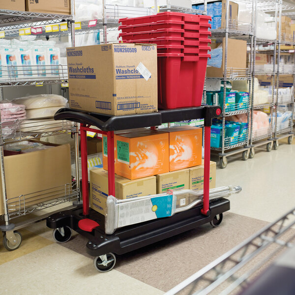 A black Rubbermaid convertible utility cart with boxes and buckets.