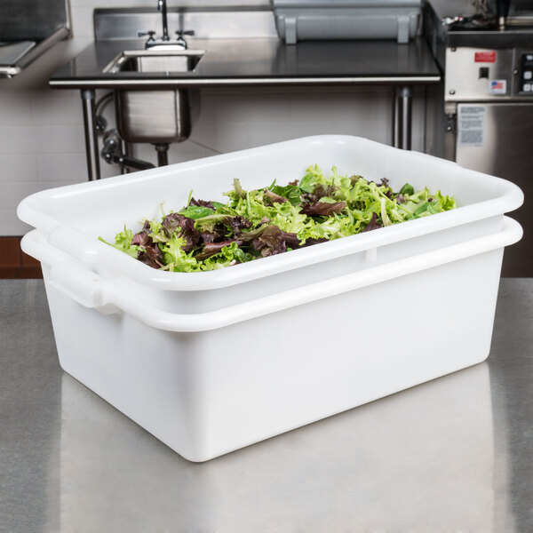 A white Tablecraft plastic freezer safe drain box filled with green lettuce.