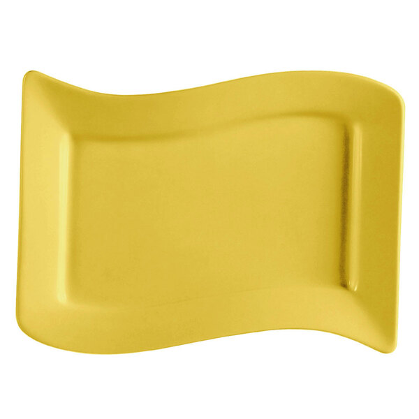 A yellow rectangular stoneware platter with a curved edge.