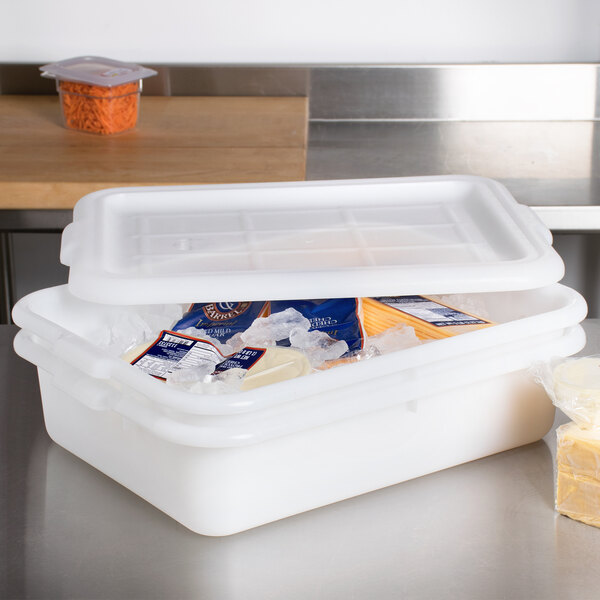 A white plastic Tablecraft drain box with ice and cheese.