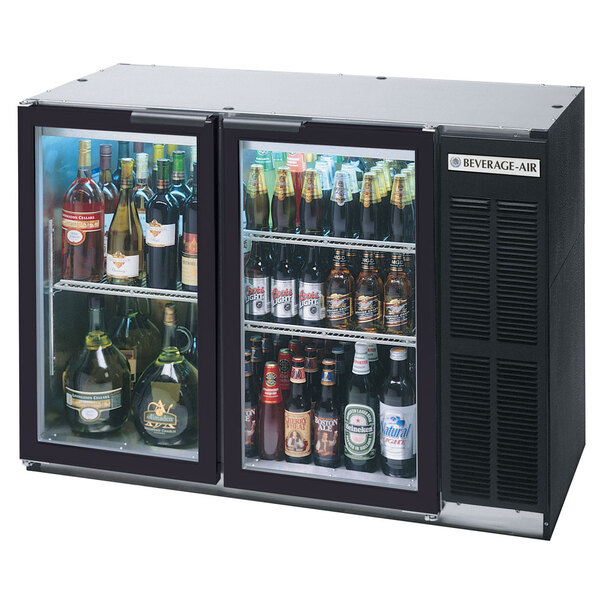 A black Beverage-Air back bar refrigerator with two glass doors filled with bottles of beer.
