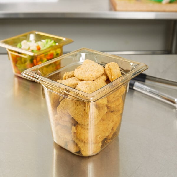 A Vollrath plastic food pan filled with food on a counter.