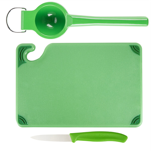 A green Saf-T-Grip cutting board with a knife.