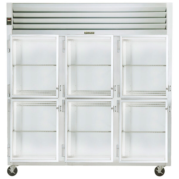 A Traulsen white refrigerator with three glass doors and shelves.