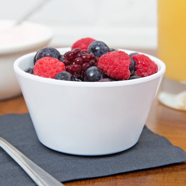A close-up of a white GET SuperMel bowl filled with berries.