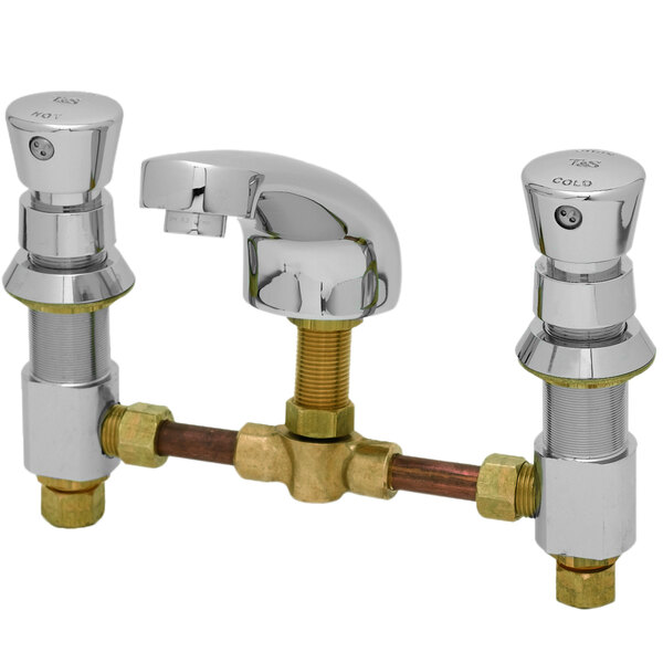A close-up of a T&S WaterSense faucet with brass handles and push button caps.