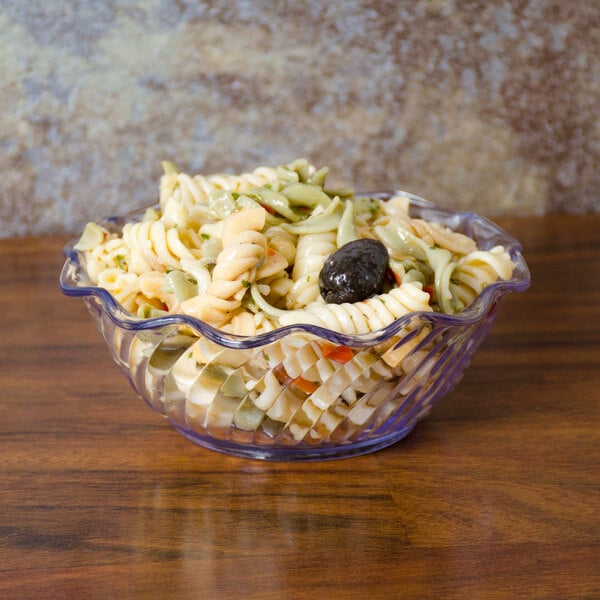 A Carlisle clear tulip dessert dish filled with pasta and olives.