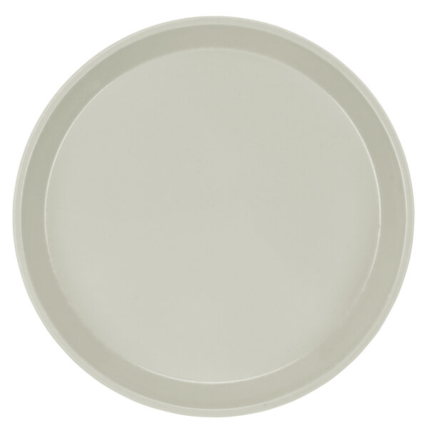 A close-up of a round white Cambro tray with a round rim.