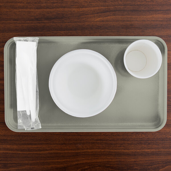 A rectangular Cambro tray with a white plate, bowl, and cup on it.